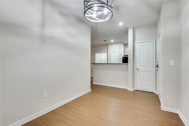 a view of a room with wooden floor and painting on the wall