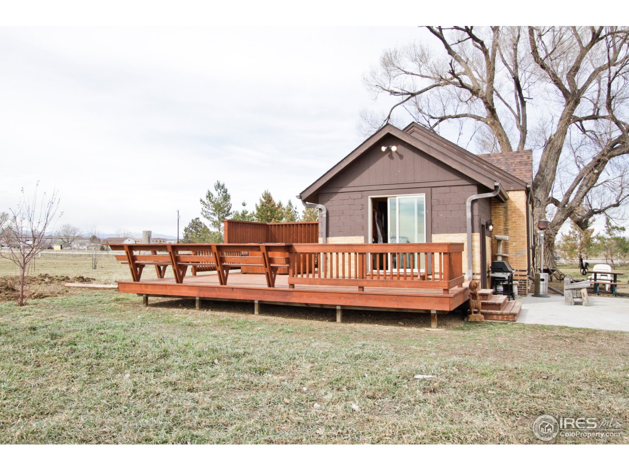 a view of a house with a yard and sitting area