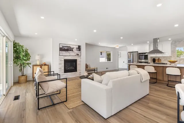 a kitchen with stainless steel appliances granite countertop a sink and a refrigerator
