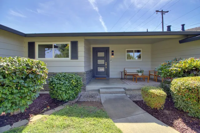 a front view of a house with garden