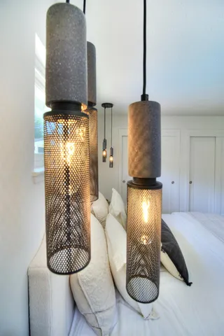 a view of a patio with table and chairs potted plants and floor to ceiling window