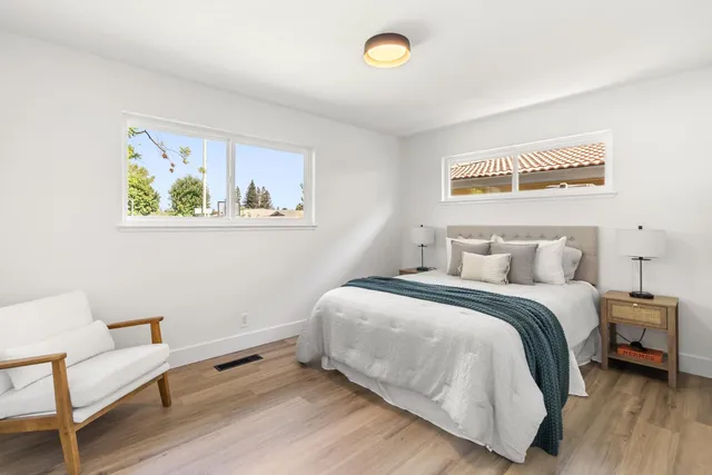 an aerial view of a house with a yard and lake view