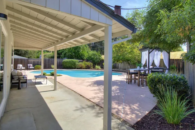 a front view of a house with a garden and yard