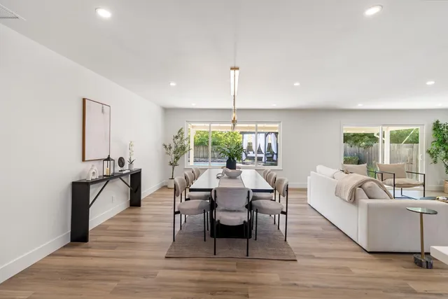 a living room with furniture wooden floor and a fireplace