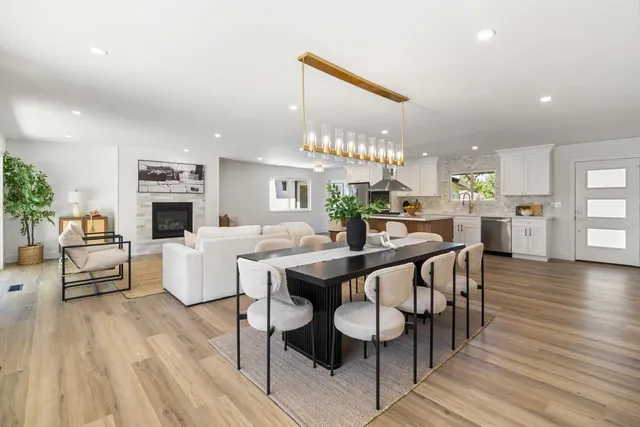 a living room with furniture a rug and a table