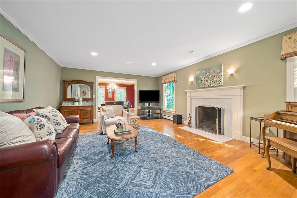155 Pine Street Medfield, MA 02052 - Photo 15 of 40 a living room with furniture a flat screen tv and a fireplace