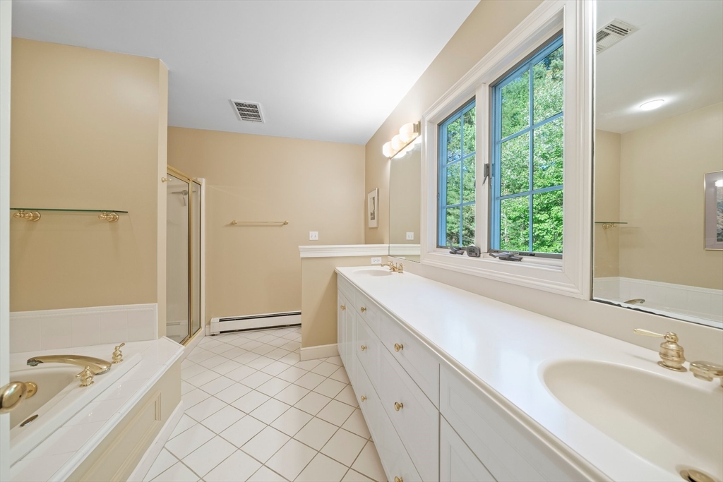 155 Pine Street Medfield, MA 02052 - Photo 19 of 40 a spacious bathroom with a granite countertop sink and a large mirror