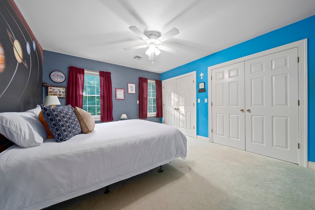 155 Pine Street Medfield, MA 02052 - Photo 20 of 40 a bedroom with a large bed and a chandelier