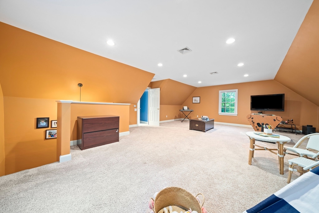 155 Pine Street Medfield, MA 02052 - Photo 25 of 40 a large room with furniture a flat screen tv and a fireplace