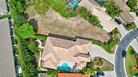 an aerial view of a house with a yard and potted plants
