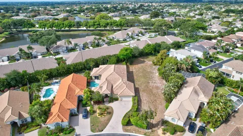 an aerial view of residential houses with outdoor space and river