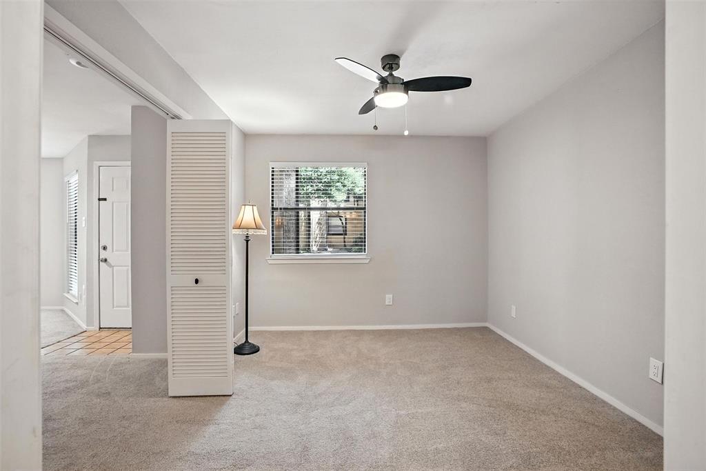 3022 Forest Lane, Unit 308 Dallas, TX 75234 - Photo 12 of 21 an empty room with windows and fan