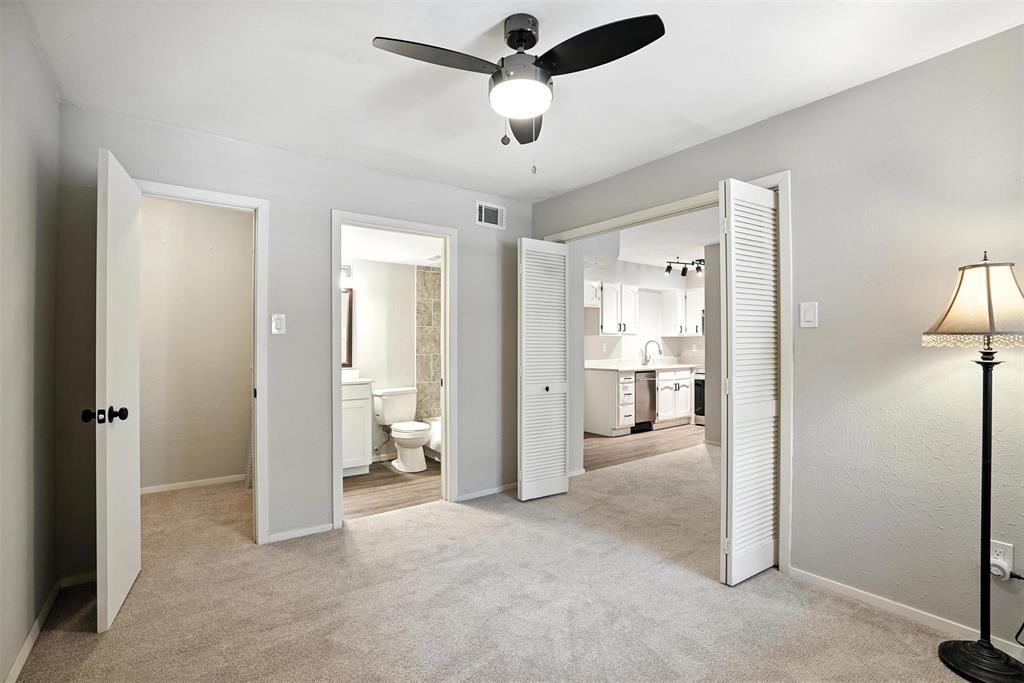 3022 Forest Lane, Unit 308 Dallas, TX 75234 - Photo 13 of 21 a view of a hallway with furniture and a ceiling fan