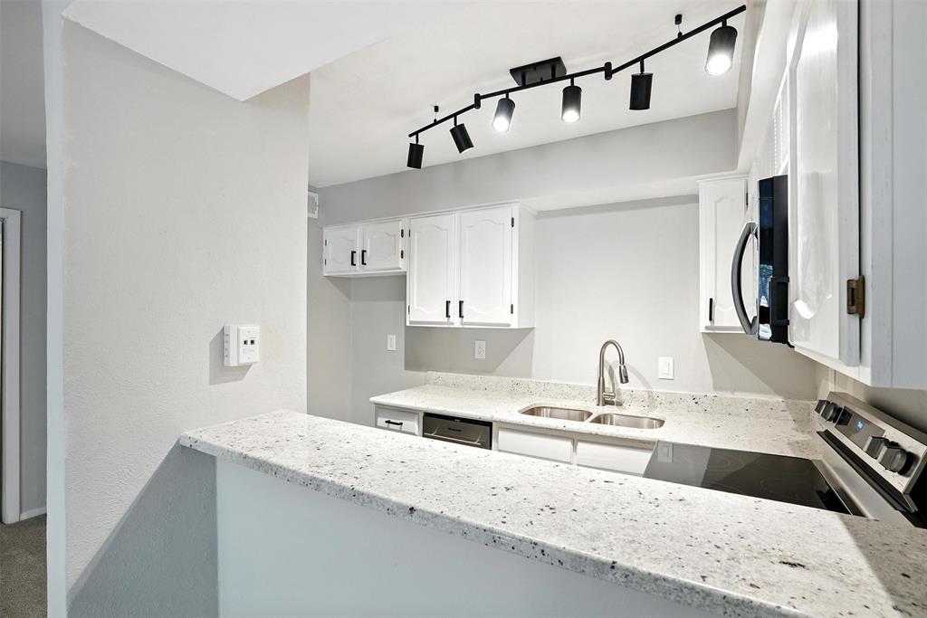 a kitchen with a sink and a refrigerator