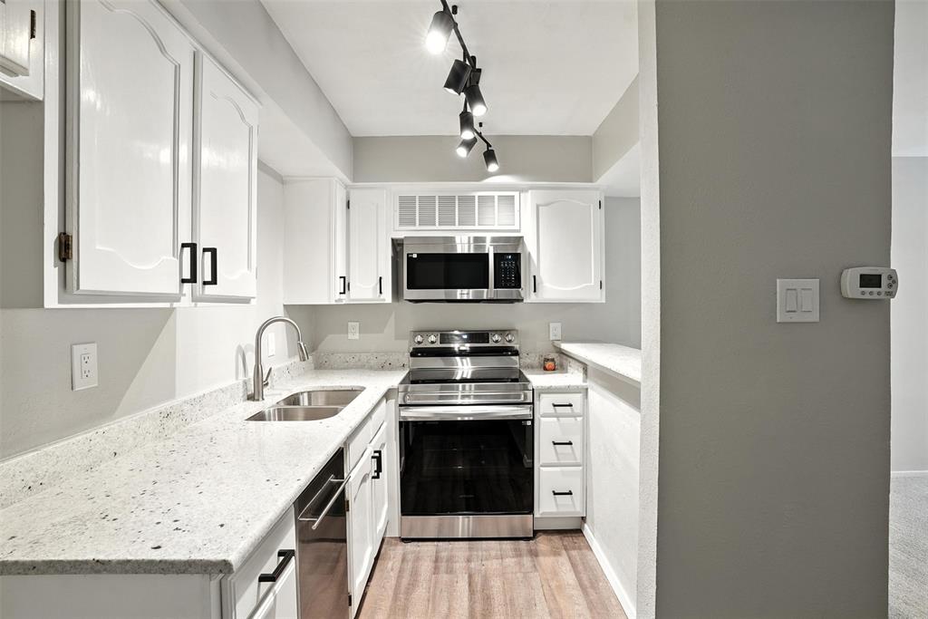 3022 Forest Lane, Unit 308 Dallas, TX 75234 - Photo 2 of 21 a kitchen with a stove and a sink