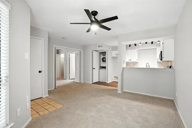 a view of kitchen with refrigerator and window