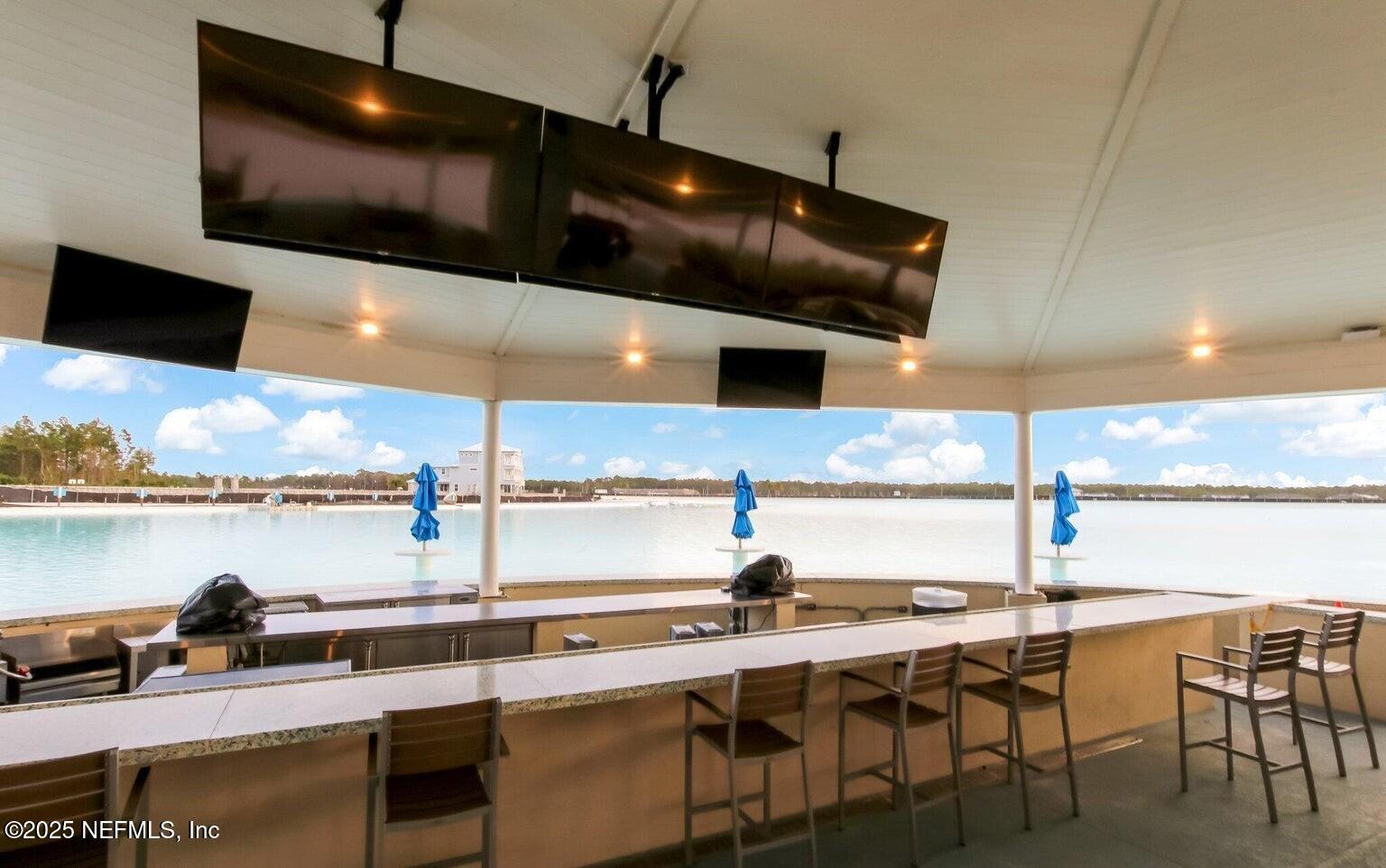 97 Marquesa Circle St. Johns, FL 32259 - Photo 77 of 86 a kitchen with a table chairs and flat screen tv