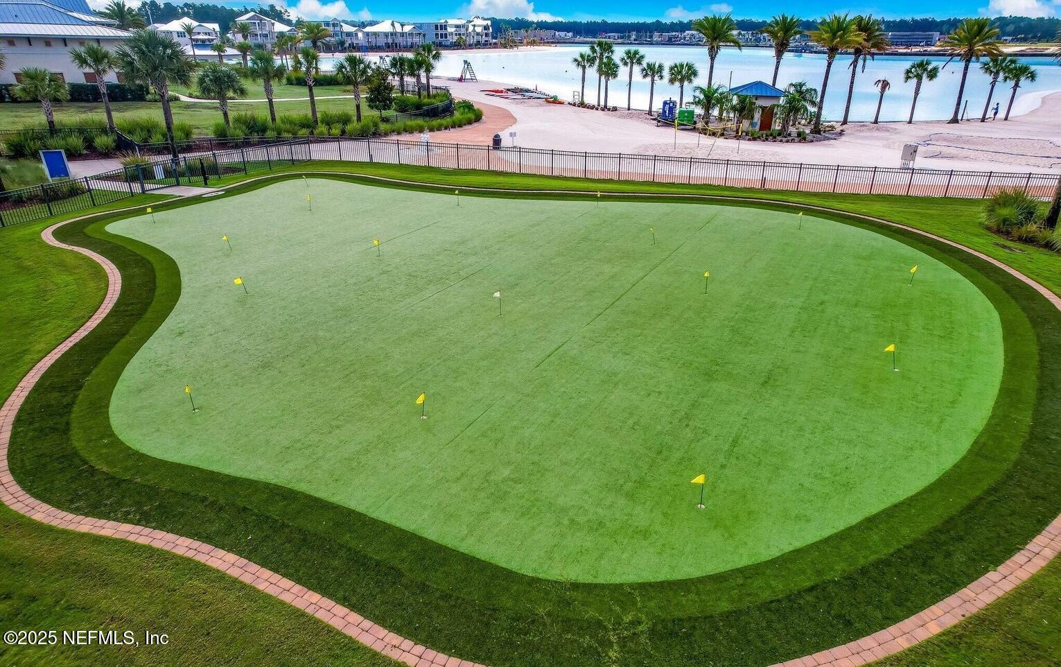 97 Marquesa Circle St. Johns, FL 32259 - Photo 81 of 86 a view of a swimming pool with a garden and plants