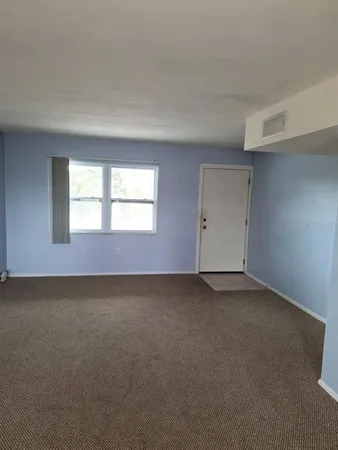 a view of empty room with windows