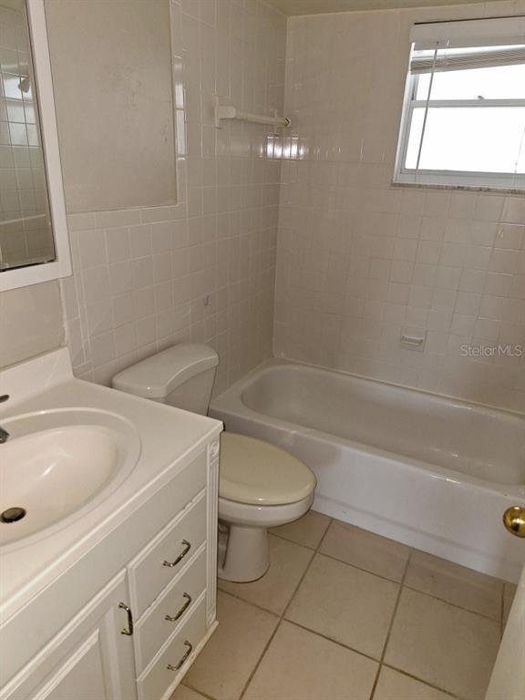 9940 47th Avenue North, Unit 320 St. Petersburg, FL 33708 - Photo 19 of 23 a bathroom with a sink a toilet and shower