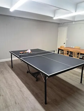 a room with gym equipment and a flat screen tv