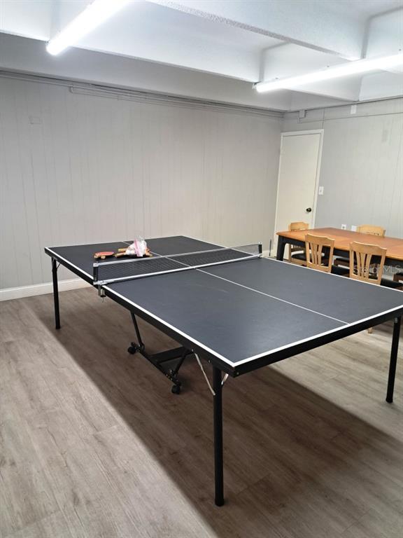 9940 47th Avenue North, Unit 320 St. Petersburg, FL 33708 - Photo 5 of 23 a room with wooden floor and pool table