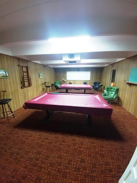 9940 47th Avenue North, Unit 320 St. Petersburg, FL 33708 - Photo 9 of 23 a bed room with a bed and a chair