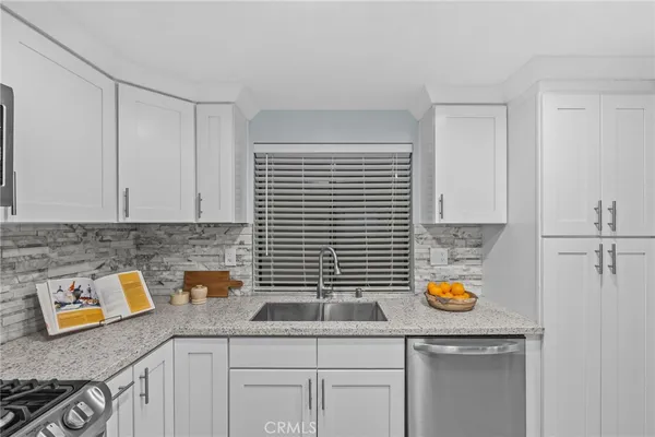 a kitchen with a sink and cabinets