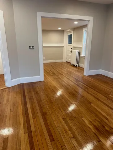 a view of a room with wooden floor and furniture