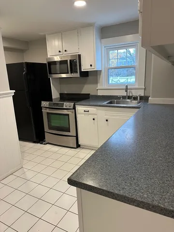 a kitchen with stainless steel appliances a sink stove and refrigerator