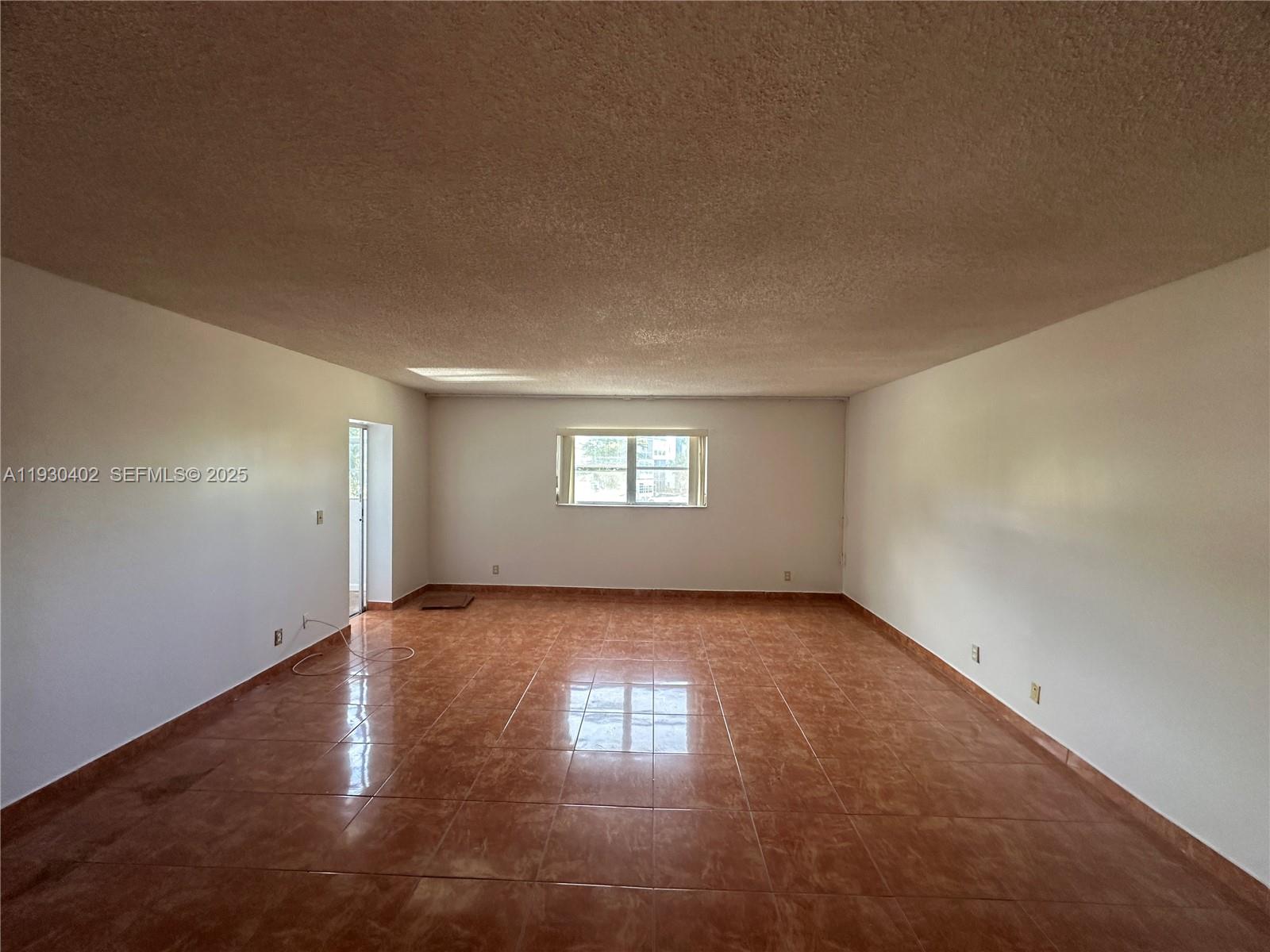 4740 Northwest 21st Street, Unit 214 Lauderhill, FL 33313 - Photo 14 of 15 an empty room with window