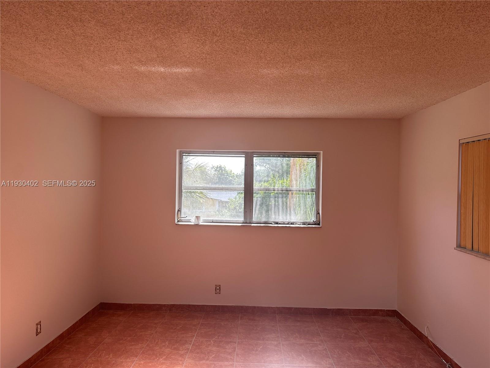 4740 Northwest 21st Street, Unit 214 Lauderhill, FL 33313 - Photo 5 of 15 an empty room with a window
