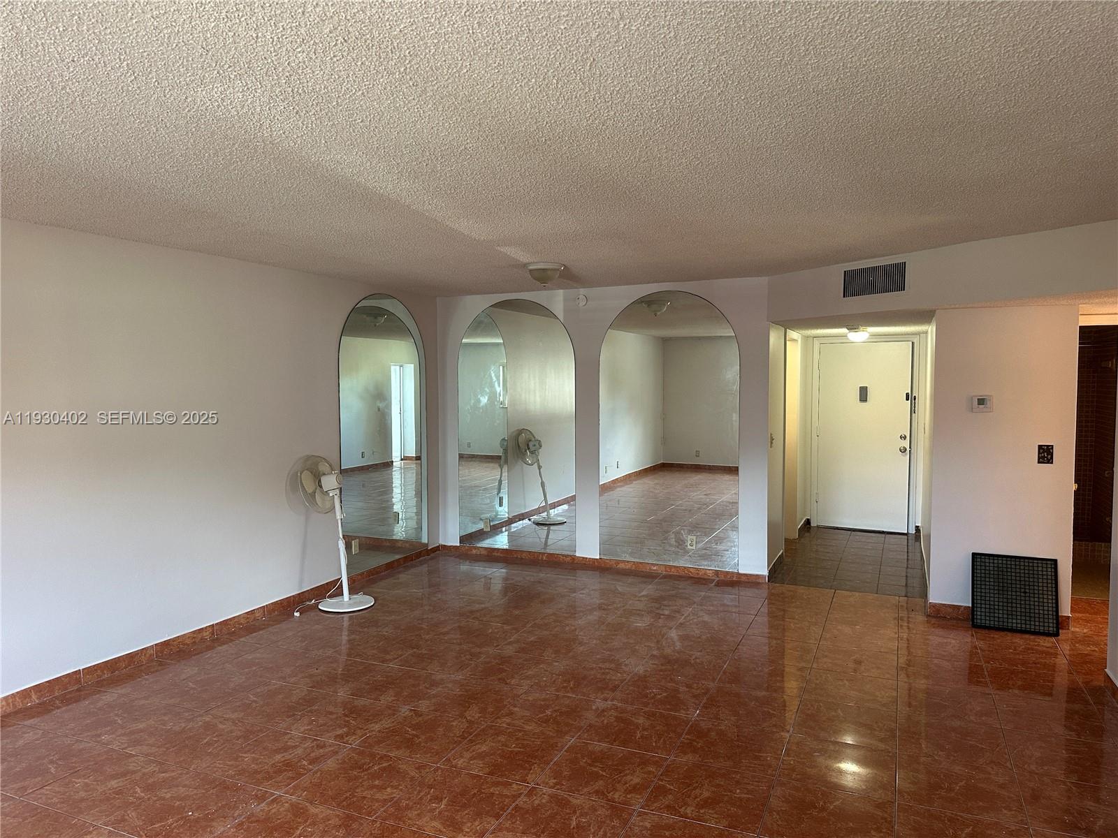 4740 Northwest 21st Street, Unit 214 Lauderhill, FL 33313 - Photo 8 of 15 an empty room with wooden floor and windows