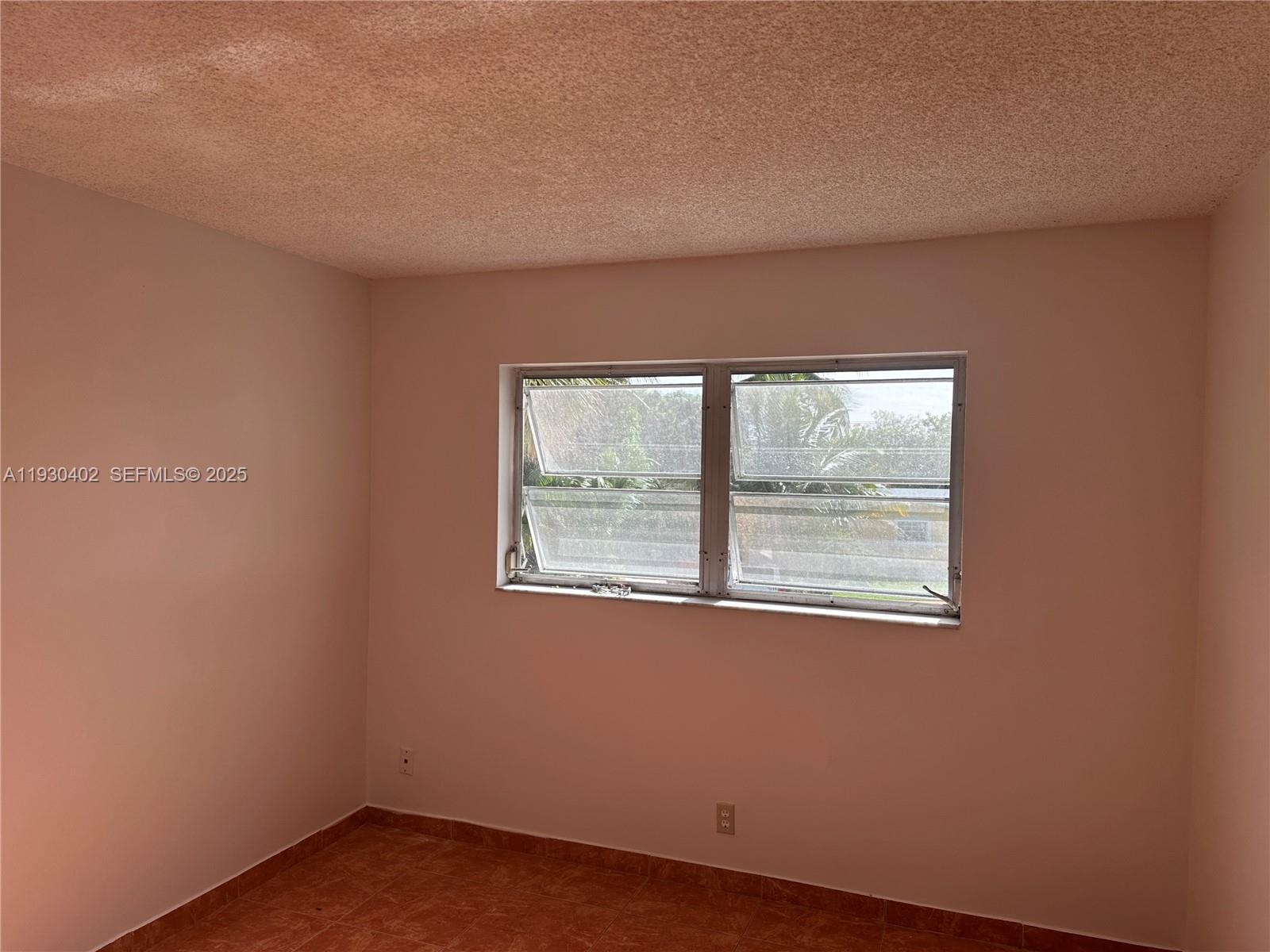 4740 Northwest 21st Street, Unit 214 Lauderhill, FL 33313 - Photo 9 of 15 an empty room with a window