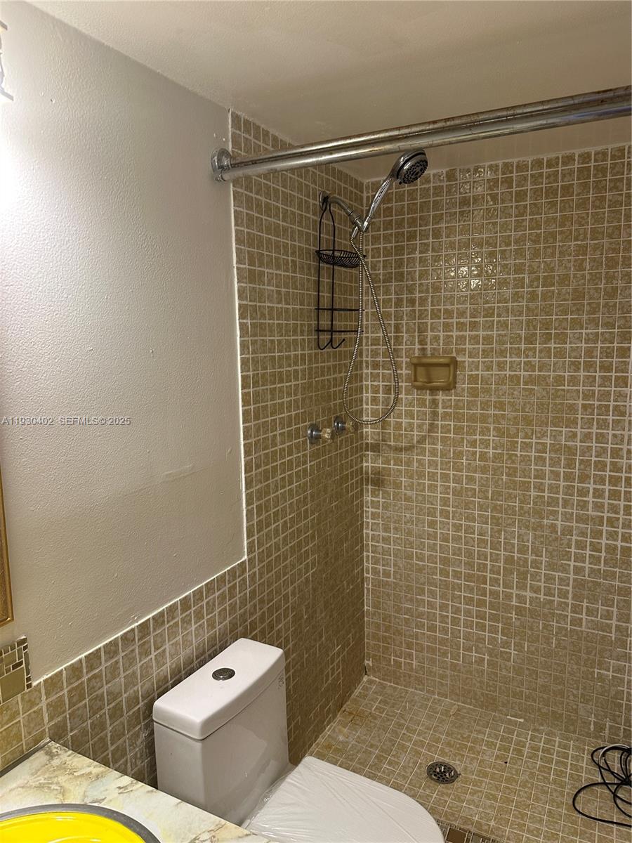 4740 Northwest 21st Street, Unit 214 Lauderhill, FL 33313 - Photo 10 of 15 a bathroom with a shower a toilet and a shower