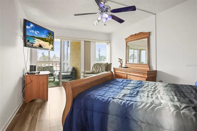 a bedroom with a large bed and a chandelier