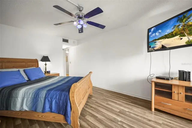 a bedroom with a bed and a flat screen tv