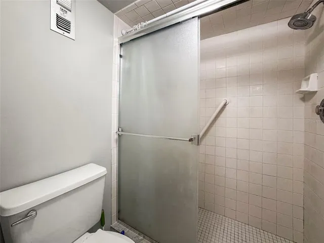 a bathroom with a toilet and a shower