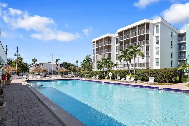 a view of a swimming pool with outdoor seating