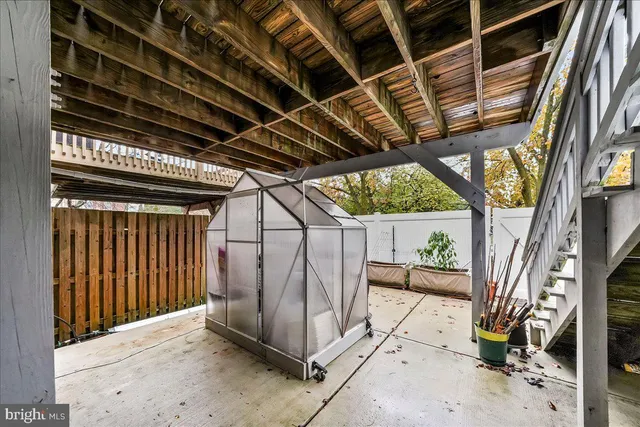 a view of a house with wooden fence