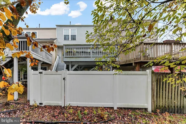 a front view of a residential apartment building with a yard and garage
