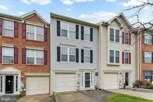 a front view of a residential apartment building with a yard
