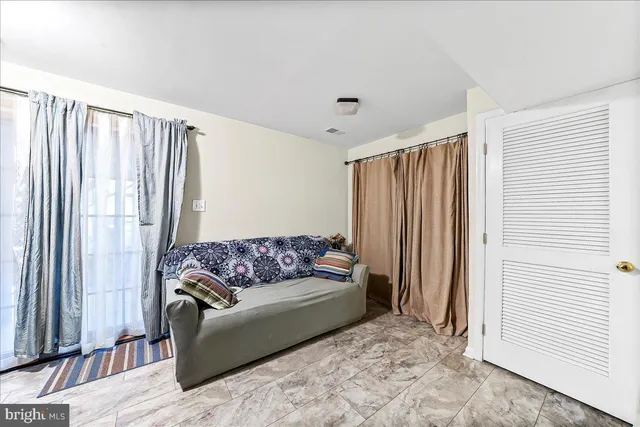 a living room with furniture a ceiling fan and a rug