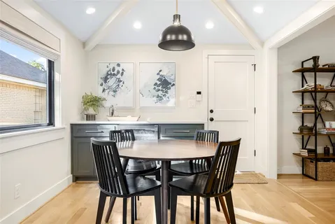 a view of a dining room with furniture and window