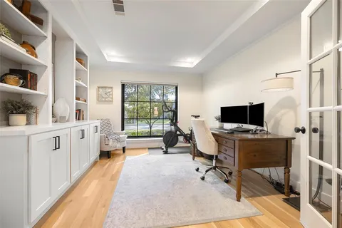 a view of a workspace with furniture and a window