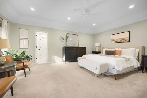 a spacious bedroom with a bed and furniture