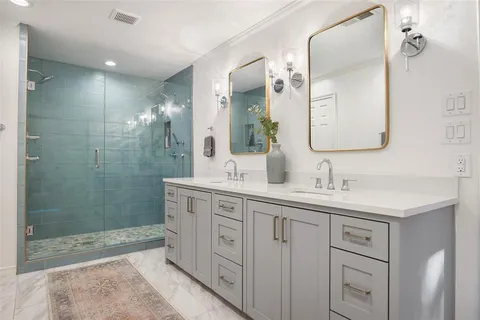 a bathroom with a granite countertop sink mirror and double