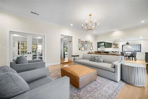 a living room with furniture and a chandelier