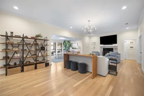 a living room with furniture a flat screen tv and kitchen view