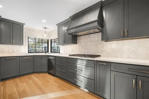 a kitchen with a sink stove and cabinets